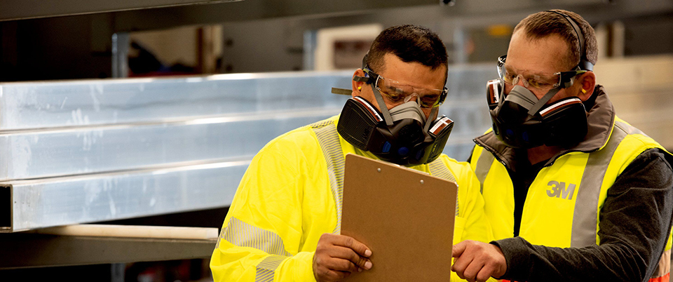 2 workers wearing the new 3M secure click respirators