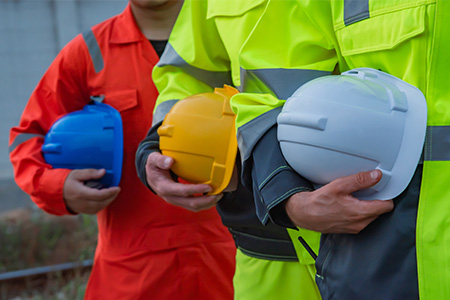 Construction workers in safety gear with colourful safety helmets